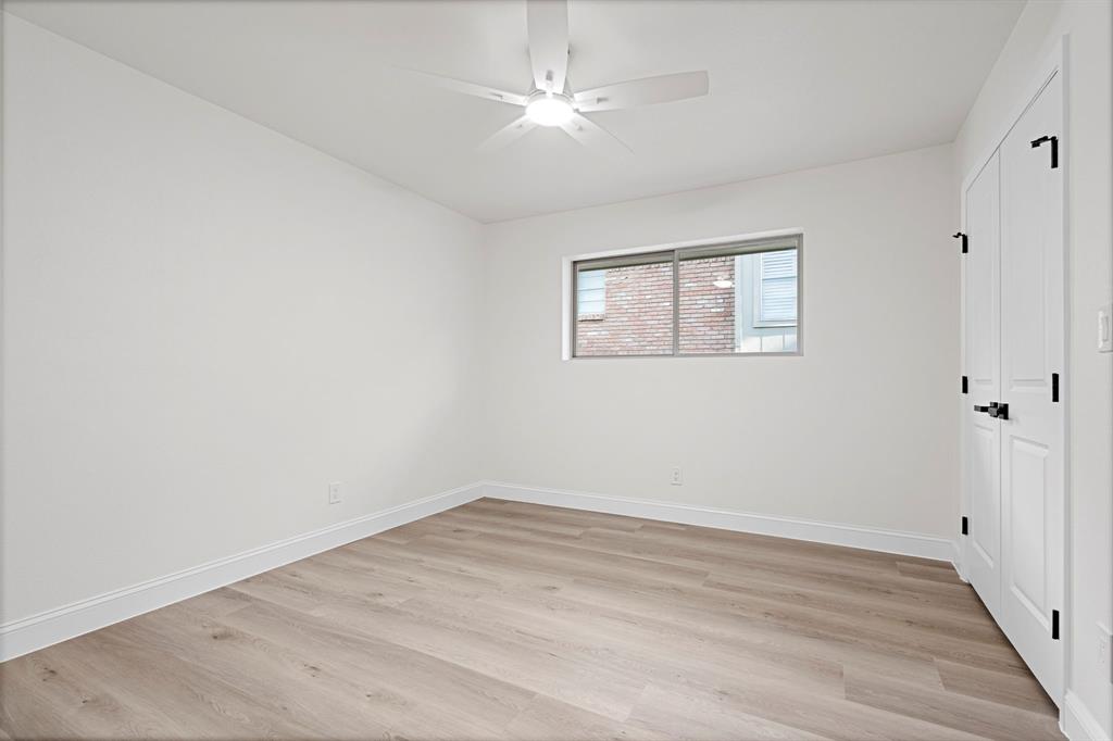 9376 Briarhurst Drive Dallas, TX 75243 - Photo 29 of 38 wooden floor in an empty room with a window
