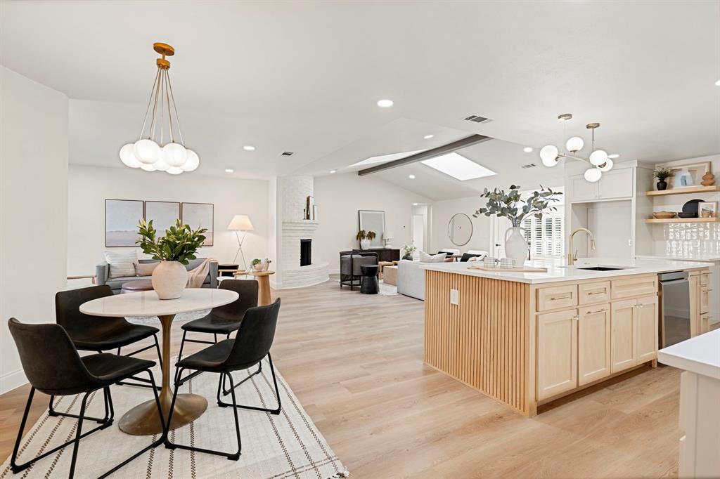 9376 Briarhurst Drive Dallas, TX 75243 - Photo 8 of 38 a kitchen with center island table and chairs in it