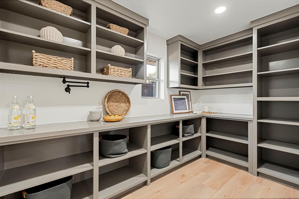 9376 Briarhurst Drive Dallas, TX 75243 - Photo 10 of 38 a view of a storage and utility room with wooden floor and cabinets