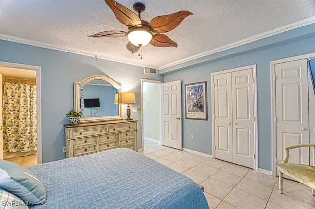 a bedroom with a bed and a chair