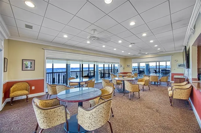 a living room with furniture a flat screen tv and a large window