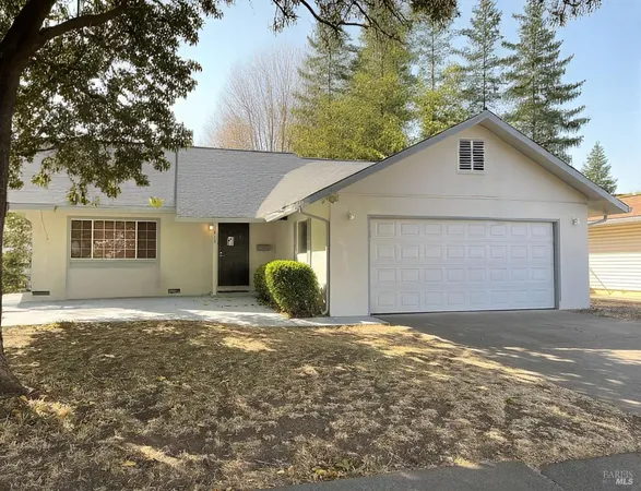 a view of a house with a yard and garage