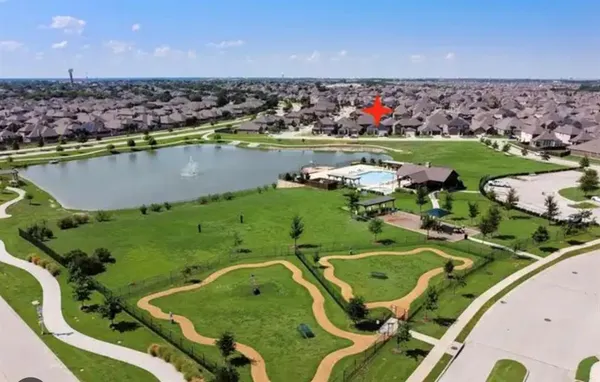 an aerial view of a residential houses with outdoor space and swimming pool