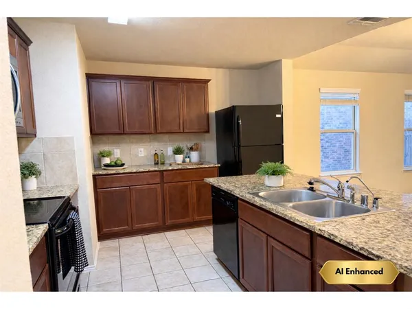 a kitchen with a sink a stove a refrigerator and wooden cabinets