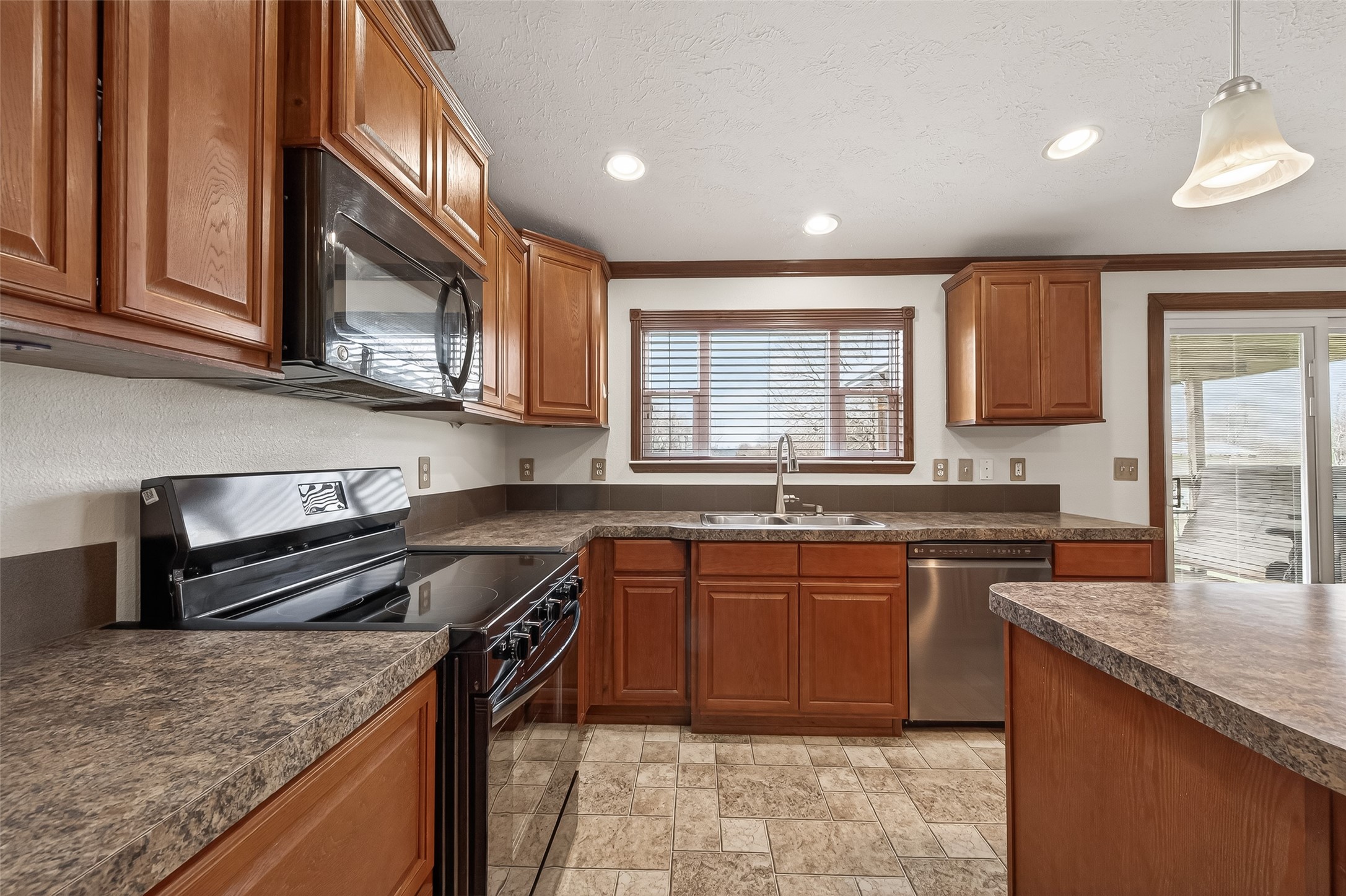 9820 Oberrender Road Needville, TX 77461 - Photo 16 of 30 a kitchen with stainless steel appliances granite countertop a sink stove and cabinets