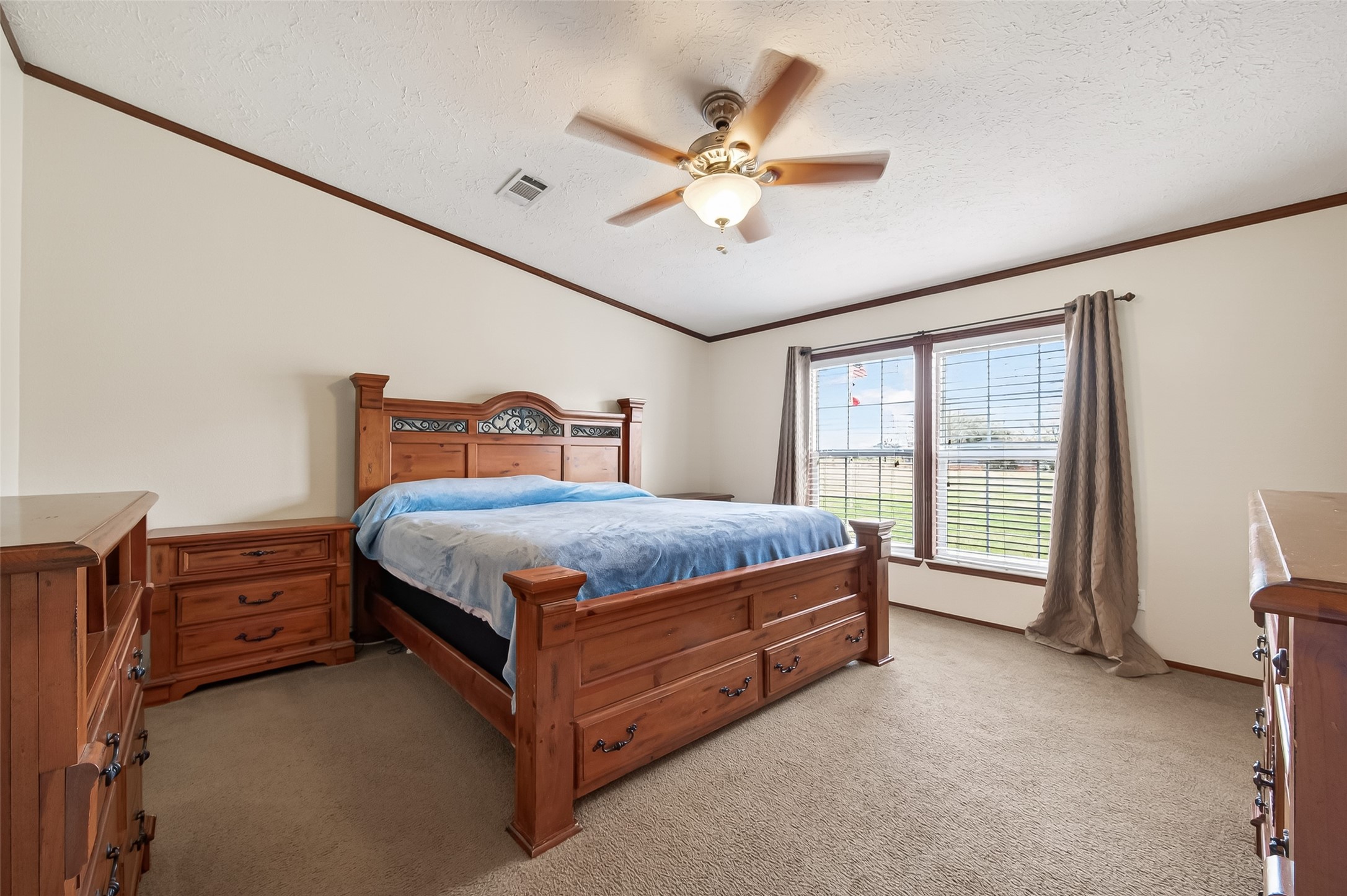 9820 Oberrender Road Needville, TX 77461 - Photo 17 of 30 a bedroom with a bed dresser and a large window