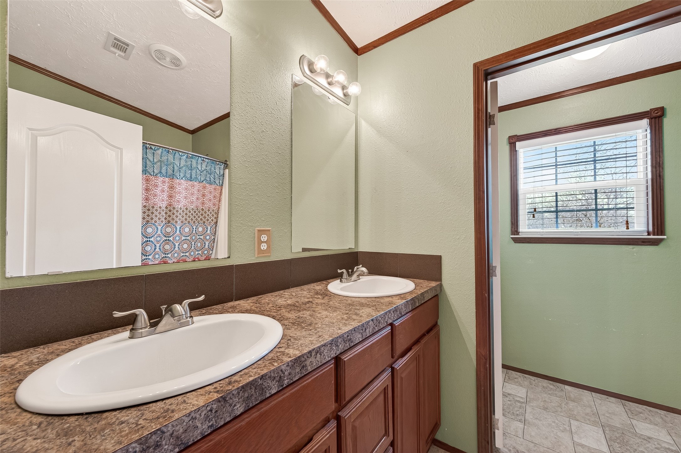 9820 Oberrender Road Needville, TX 77461 - Photo 24 of 30 a bathroom with a granite countertop sink and a mirror