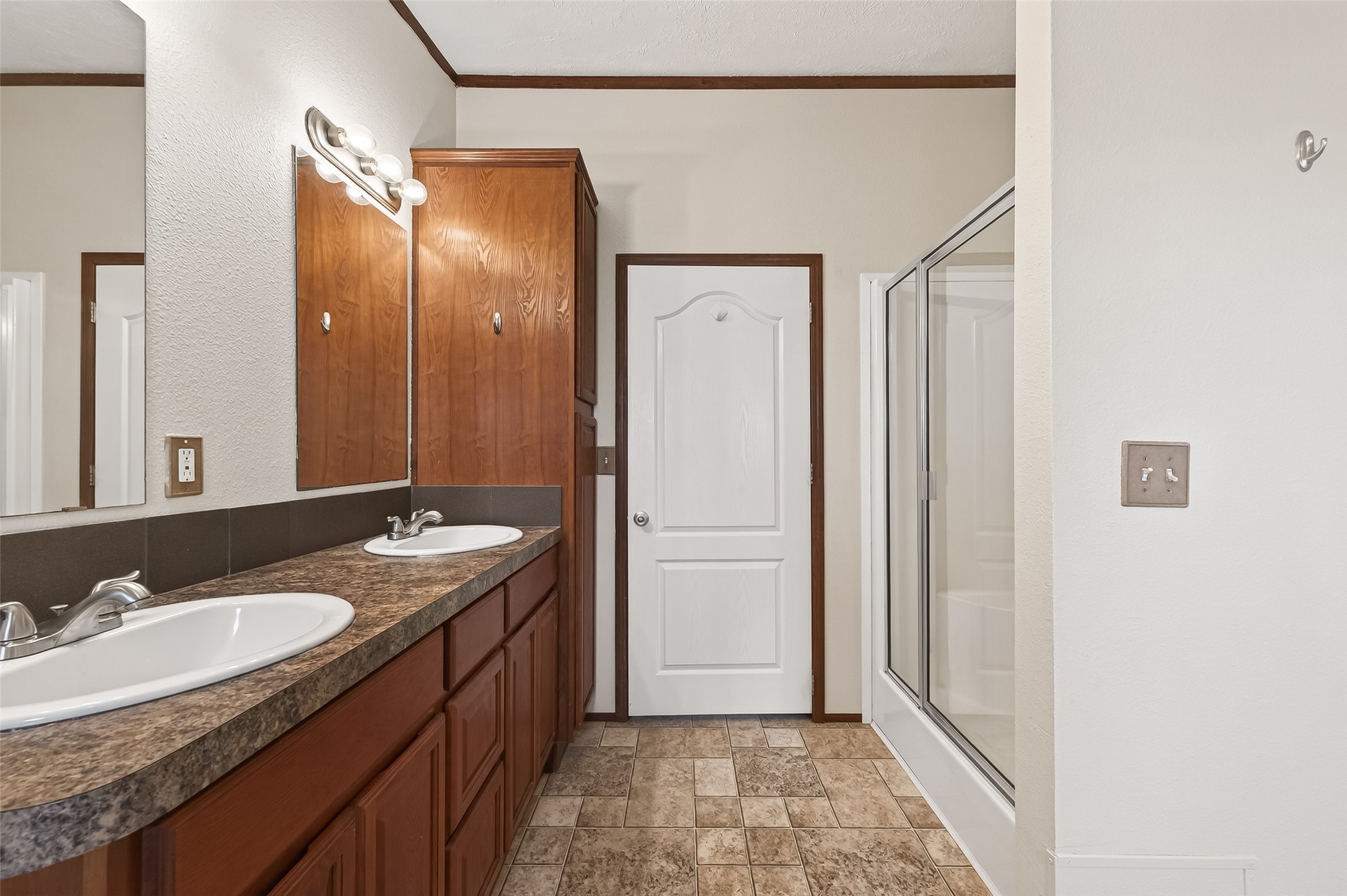 9820 Oberrender Road Needville, TX 77461 - Photo 25 of 30 a bathroom with a granite countertop sink a mirror and a shower