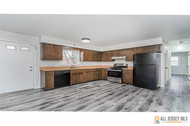a kitchen with a refrigerator and a sink