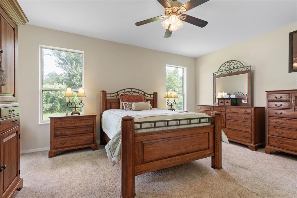 20 Rybar Lane Palm Coast, FL 32164 - Photo 15 of 40 a bedroom with a bed and a chandelier