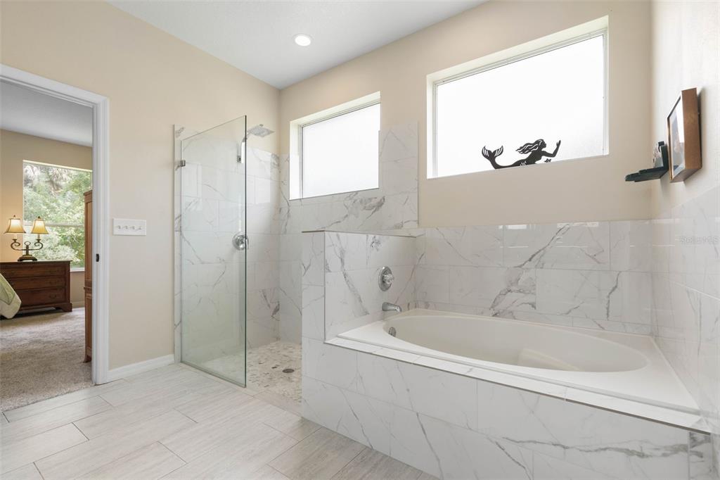20 Rybar Lane Palm Coast, FL 32164 - Photo 19 of 40 a spacious bathroom with a bathtub and a shower