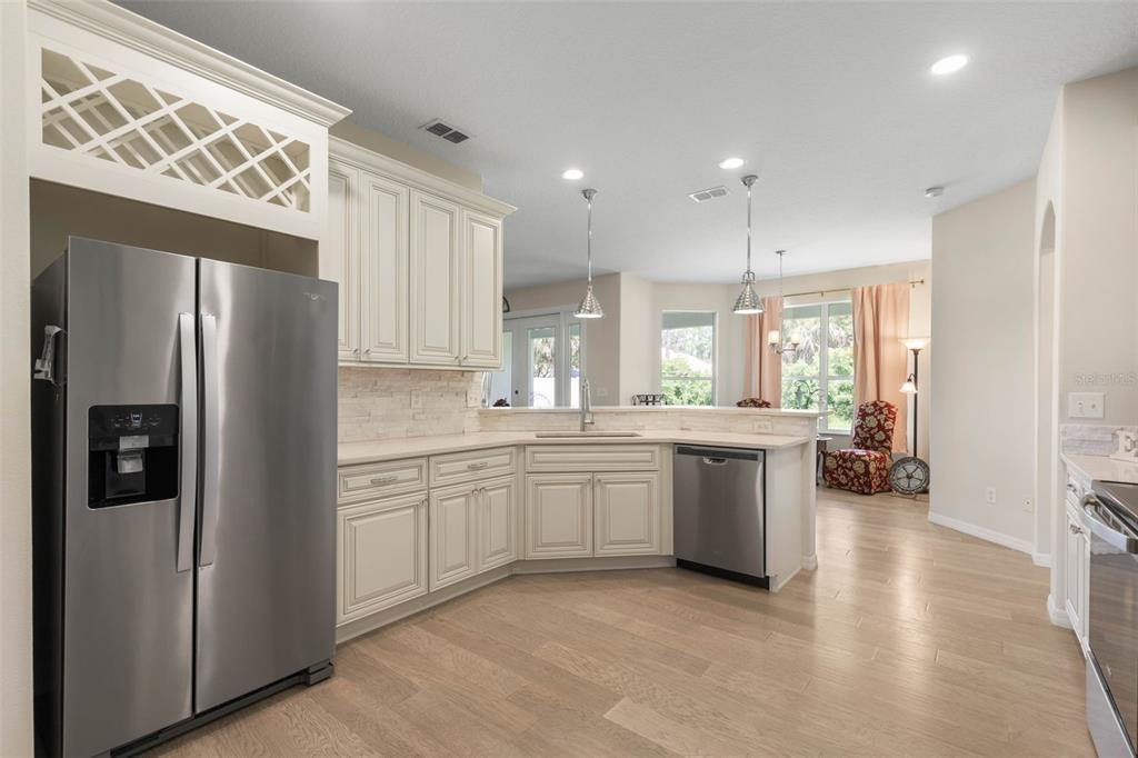 20 Rybar Lane Palm Coast, FL 32164 - Photo 2 of 40 a kitchen with stainless steel appliances granite countertop a refrigerator and a sink