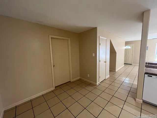 a view of a hallway to closet and utility room