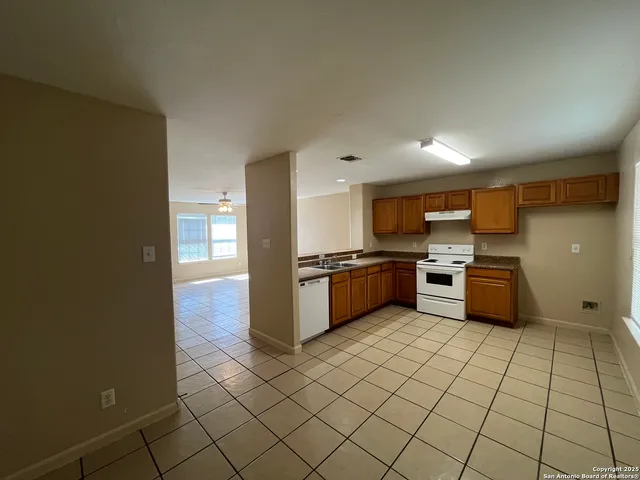 a kitchen with stainless steel appliances a sink and cabinets