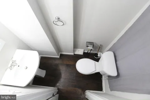 a bathroom with a sink mirror and toilet