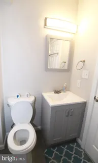 a bathroom with a sink toilet and mirror