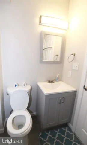 a bathroom with a sink toilet and mirror