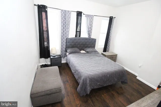 a bedroom with a bed and a mirror