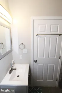 a bathroom with a sink a mirror and shower