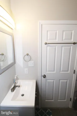 a bathroom with a sink a mirror and shower