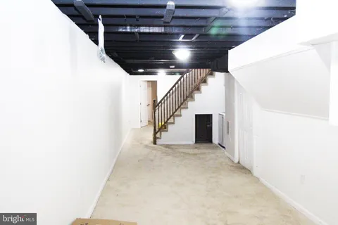 a view of an empty room with stairs