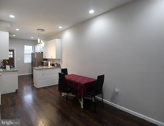 a kitchen with a table and chairs in it