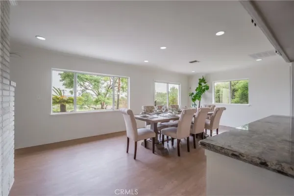 a view of a room that has a table and chairs