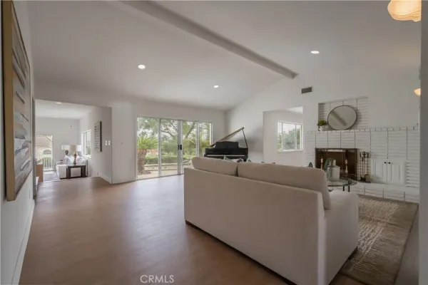 a kitchen with stainless steel appliances kitchen island granite countertop a sink stove and refrigerator