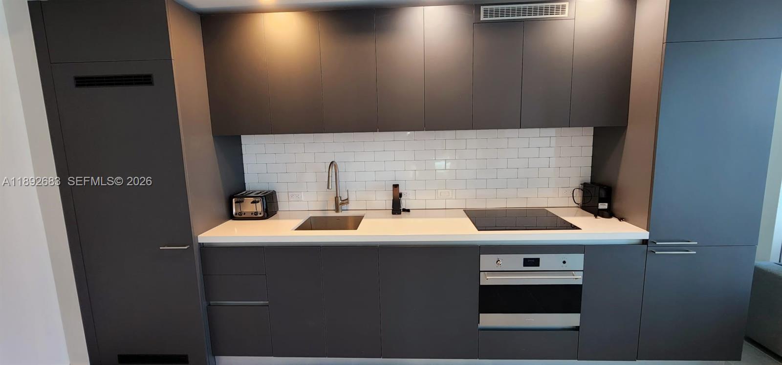 227 Northeast 2nd Street, Unit 2907 Miami, FL 33132 - Photo 2 of 58 a bathroom with a sink a toilet and mirror