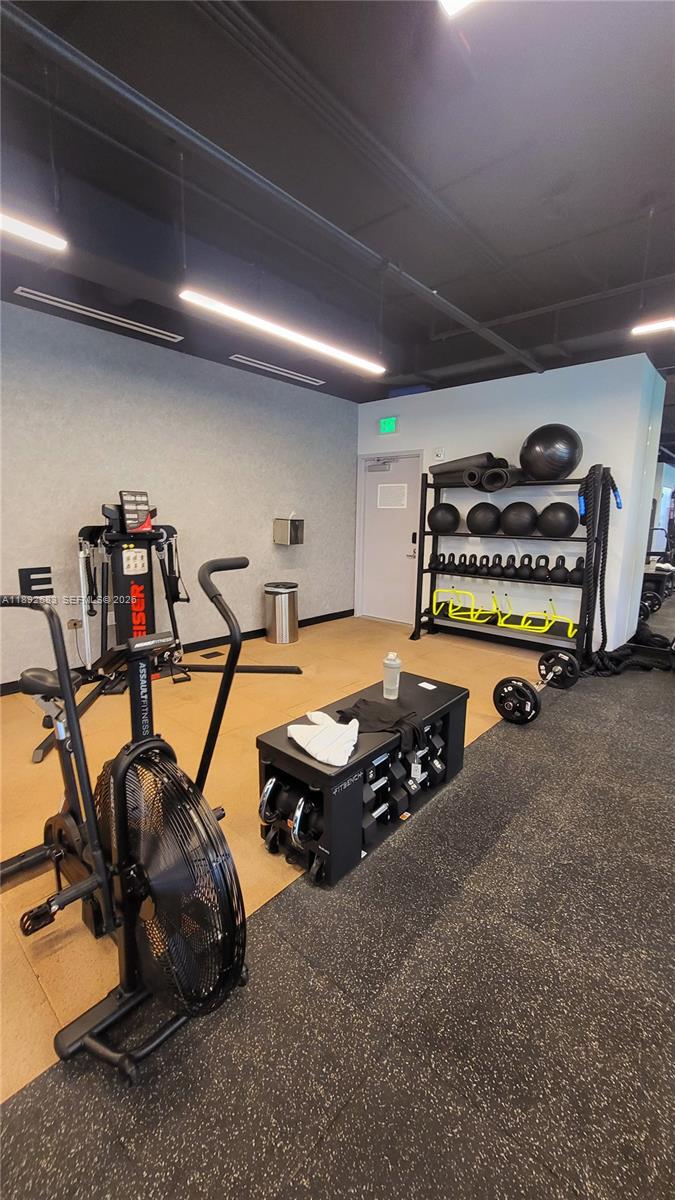 227 Northeast 2nd Street, Unit 2907 Miami, FL 33132 - Photo 36 of 58 a room with gym equipment and a table