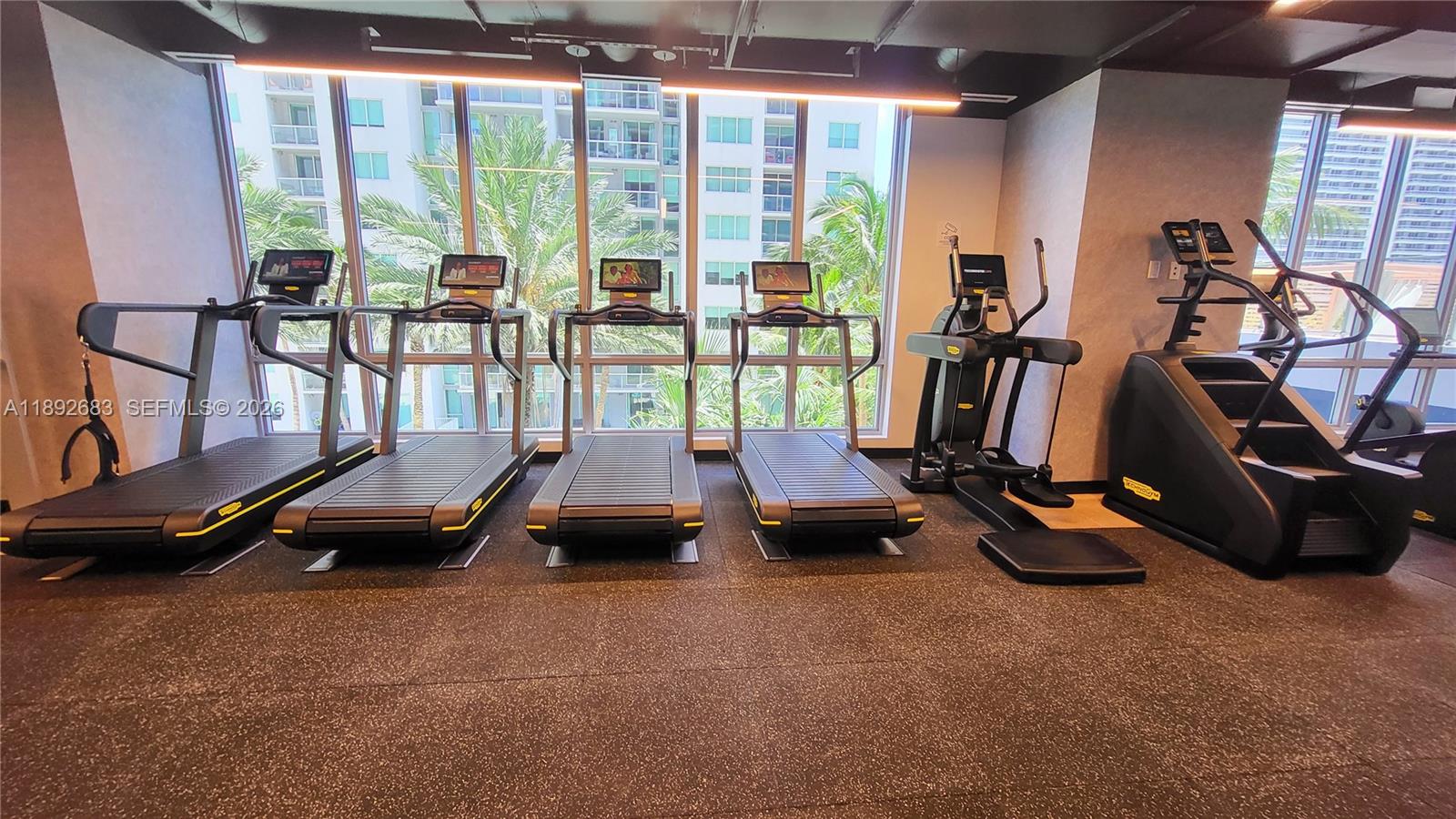 227 Northeast 2nd Street, Unit 2907 Miami, FL 33132 - Photo 37 of 58 a room with gym equipment and large windows