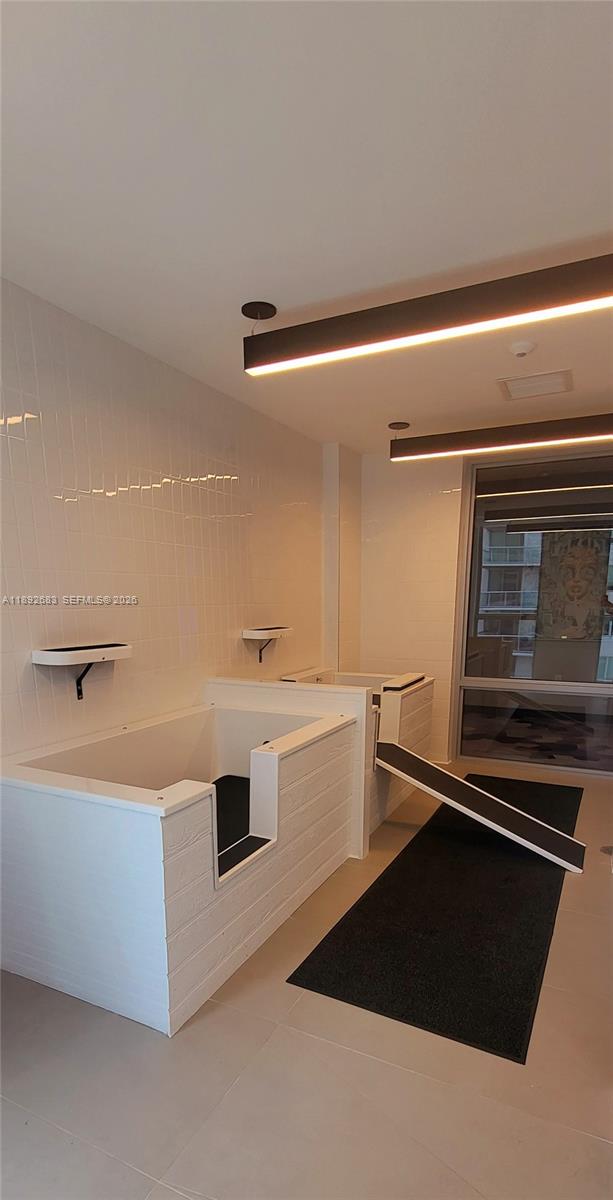 227 Northeast 2nd Street, Unit 2907 Miami, FL 33132 - Photo 45 of 58 a kitchen with a refrigerator and a sink