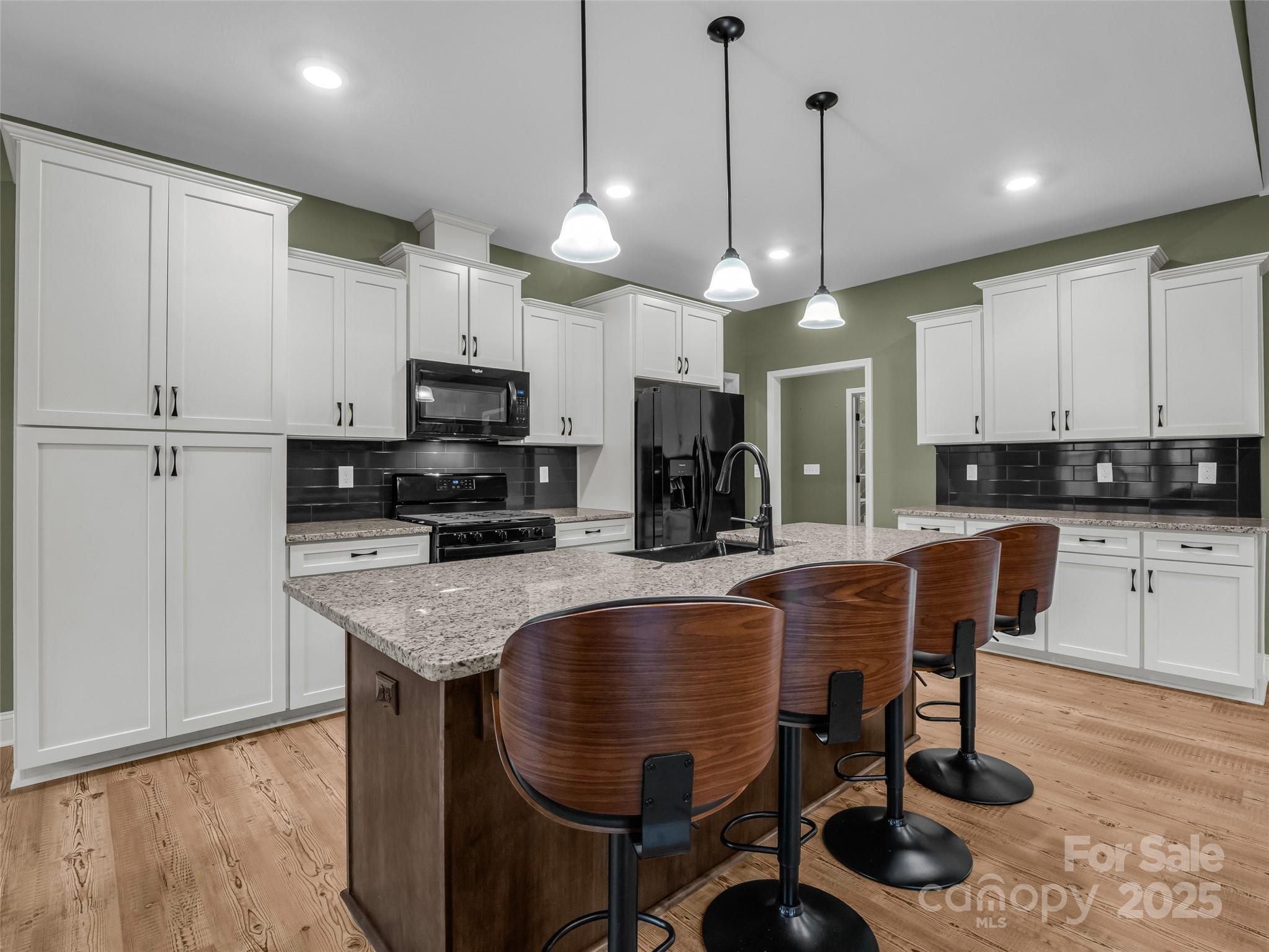 140 Cv Crst Drive Rutherfordton, NC 28139 - Photo 11 of 48 a kitchen with stainless steel appliances granite countertop a stove a refrigerator a kitchen island a sink a stove a dining table and chairs