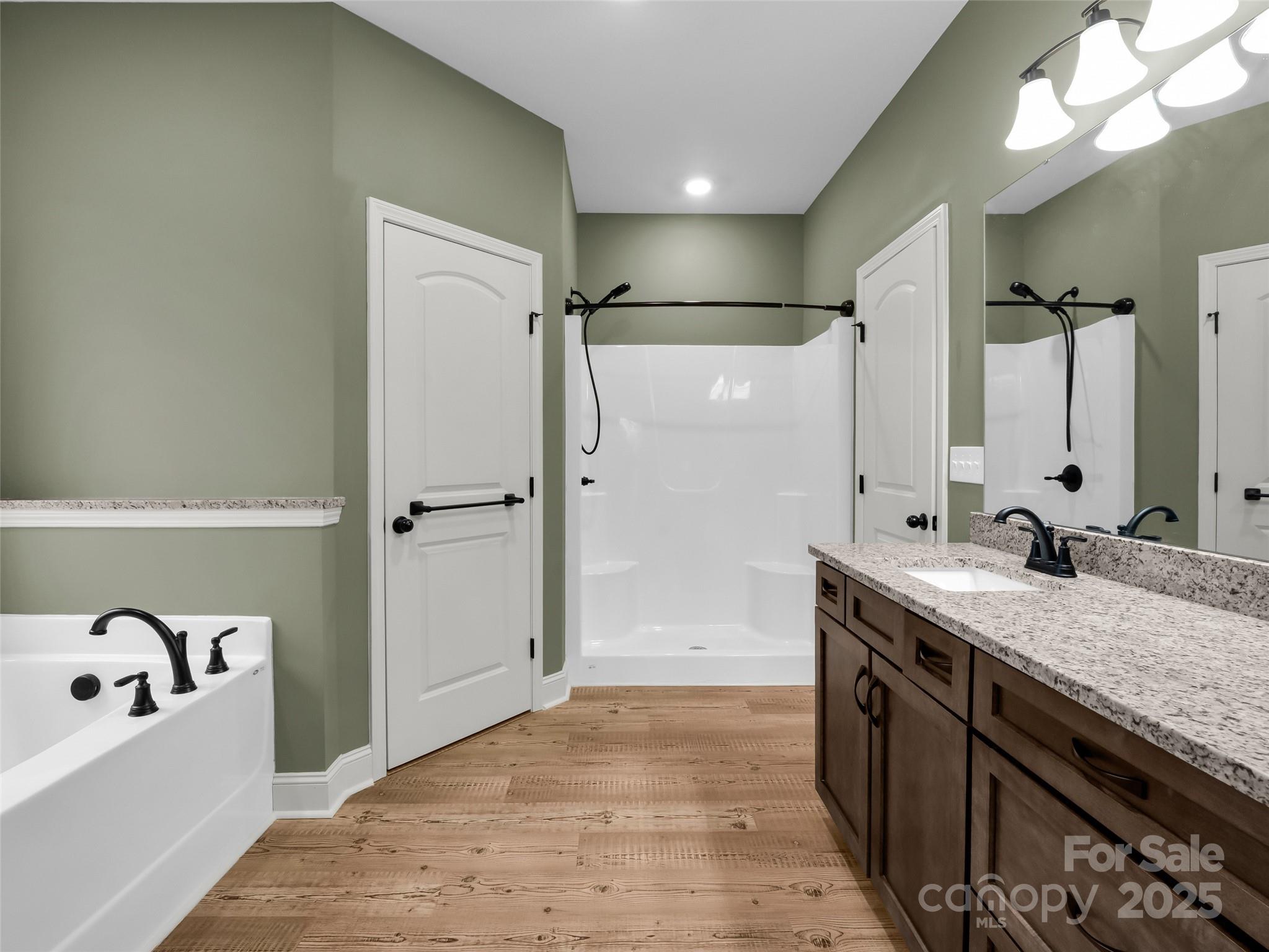 140 Cv Crst Drive Rutherfordton, NC 28139 - Photo 23 of 48 a bathroom with a granite countertop sink a toilet a mirror and shower