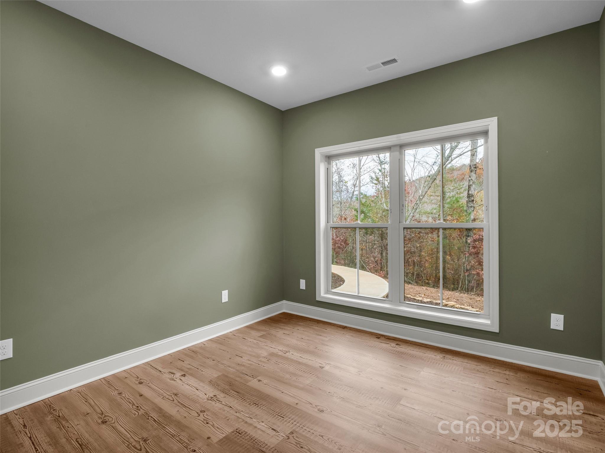 140 Cv Crst Drive Rutherfordton, NC 28139 - Photo 33 of 48 a view of an empty room with wooden floor and a window