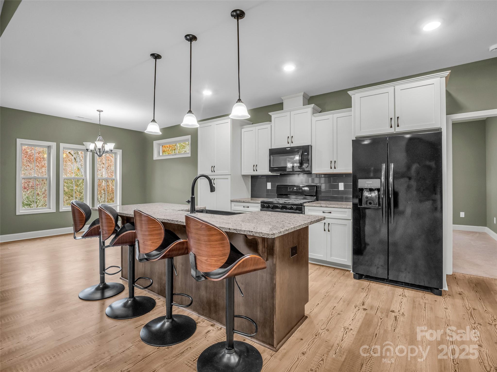 140 Cv Crst Drive Rutherfordton, NC 28139 - Photo 10 of 48 a kitchen with stainless steel appliances granite countertop a sink a stove a refrigerator cabinets and chairs