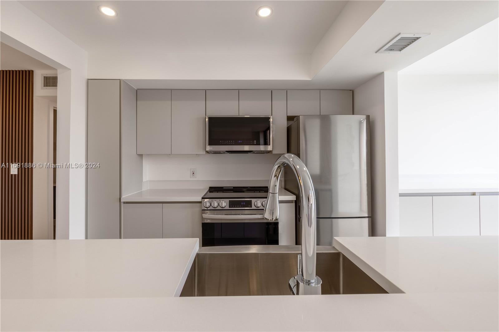 9400 West Flagler Street, Unit 413 Miami, FL 33174 - Photo 15 of 17 a kitchen with a refrigerator stove and microwave