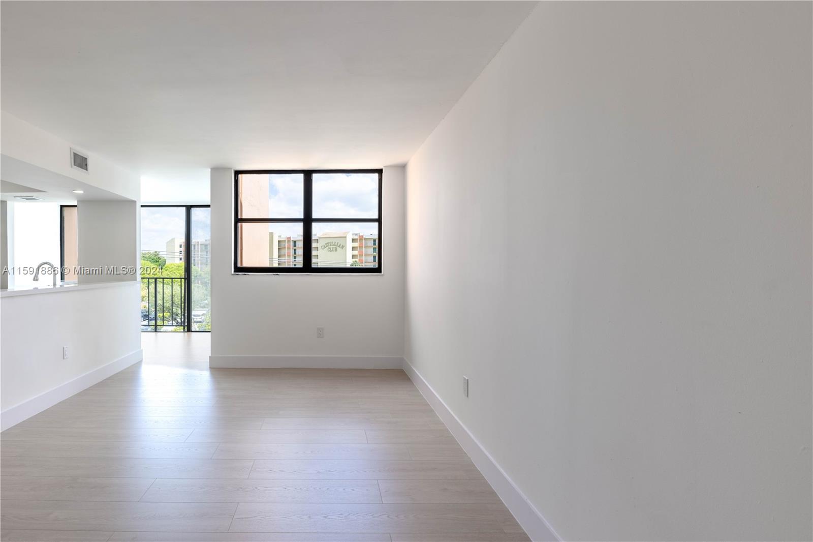 9400 West Flagler Street, Unit 413 Miami, FL 33174 - Photo 5 of 17 an empty room with wooden floor and windows