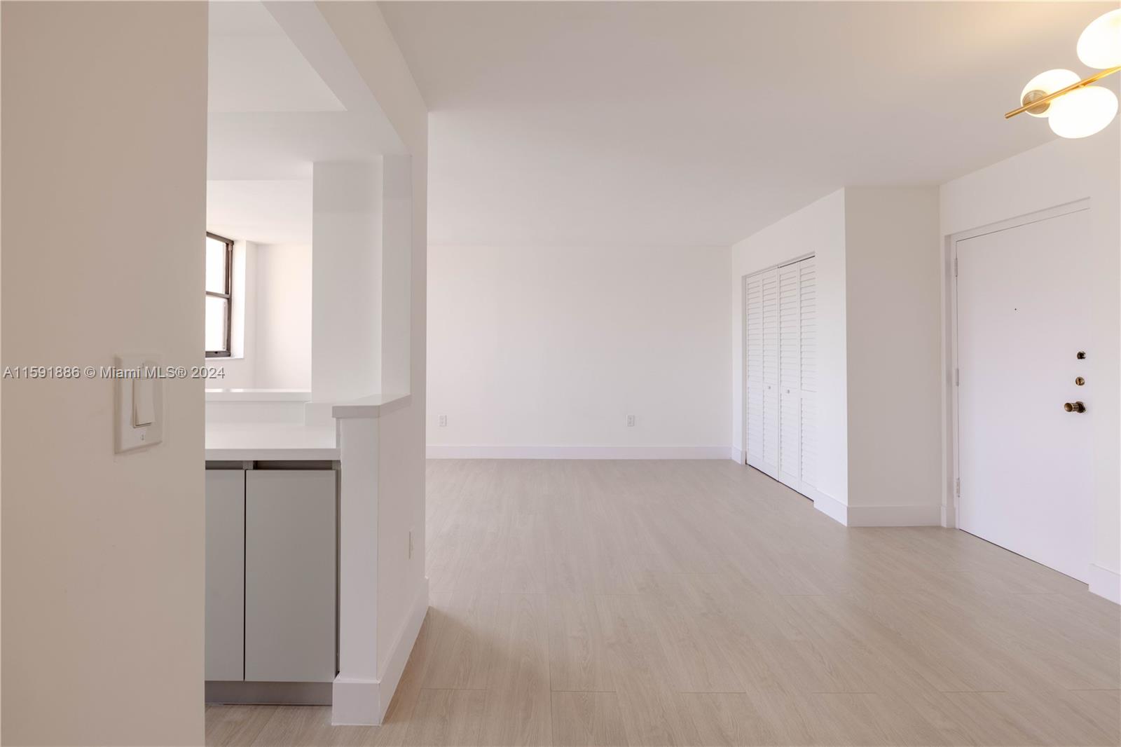 9400 West Flagler Street, Unit 413 Miami, FL 33174 - Photo 7 of 17 an empty room with closet and mirror