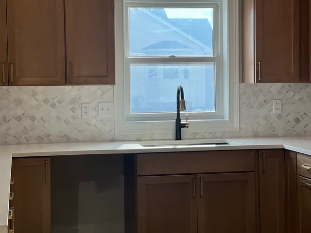 a view of a big room with wooden floor and windows