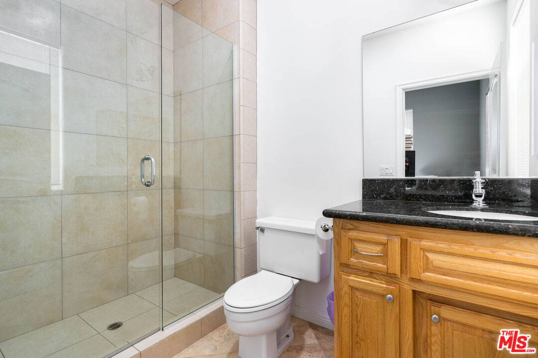 34545 Juniper Valley Road Acton, CA 93510 - Photo 14 of 34 a bathroom with a granite countertop sink a toilet and shower