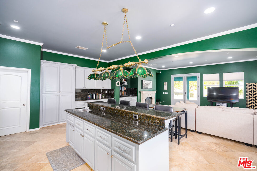 34545 Juniper Valley Road Acton, CA 93510 - Photo 6 of 34 a kitchen with kitchen island a large counter top space a sink stainless steel appliances and windows