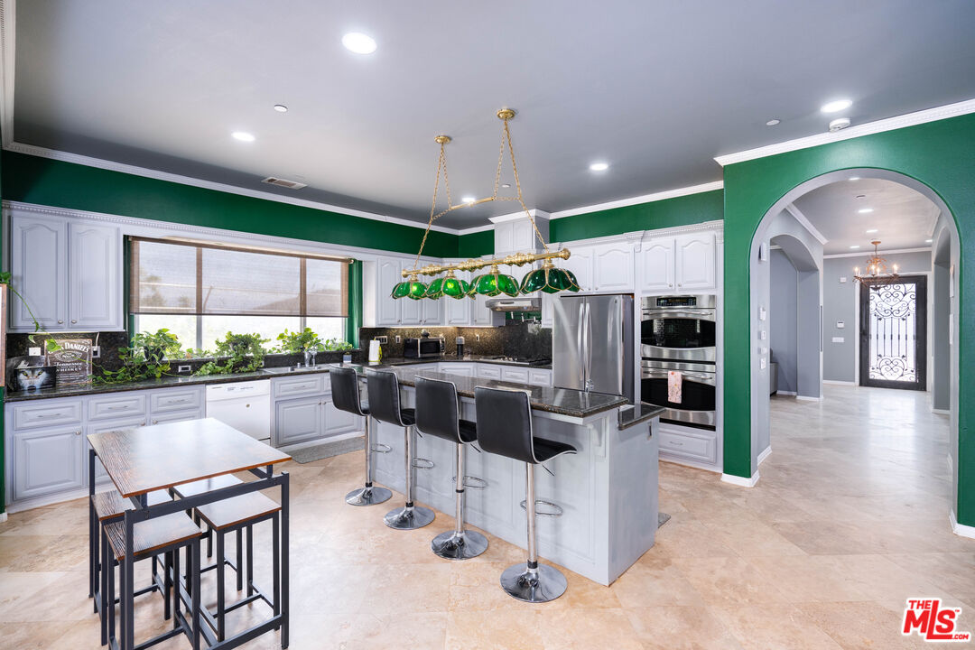 34545 Juniper Valley Road Acton, CA 93510 - Photo 9 of 34 a kitchen with stainless steel appliances kitchen island granite top and refrigerator