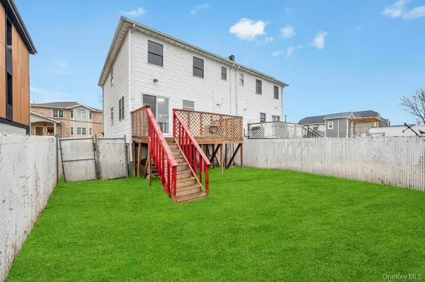 a view of a house with a yard and deck