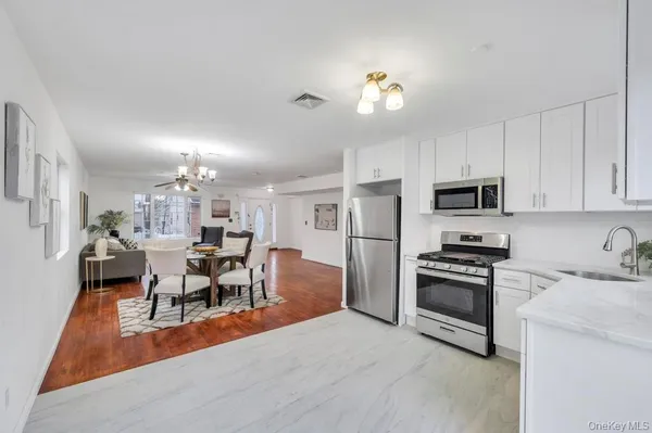 a view of a backyard with a house and a wooden fence