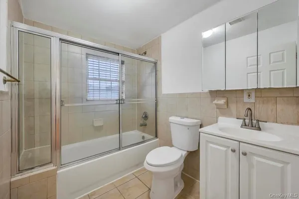 a kitchen with stainless steel appliances granite countertop a stove top oven a sink dishwasher a dining table and chairs with wooden floor
