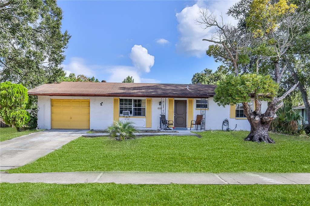 a front view of house with yard and outdoor seating