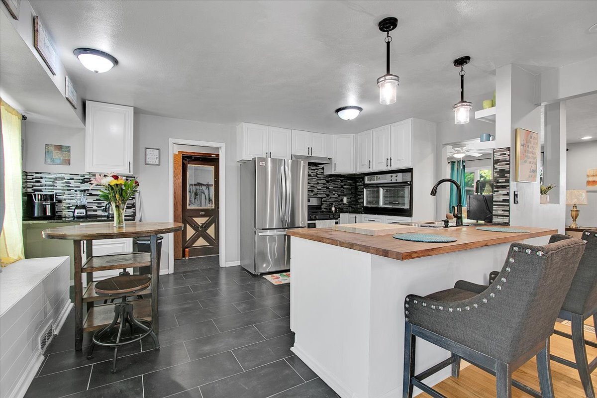 1708 Montague Road Rockford, IL 61102 - Photo 13 of 39 a kitchen with kitchen island a large counter top space appliances and cabinets