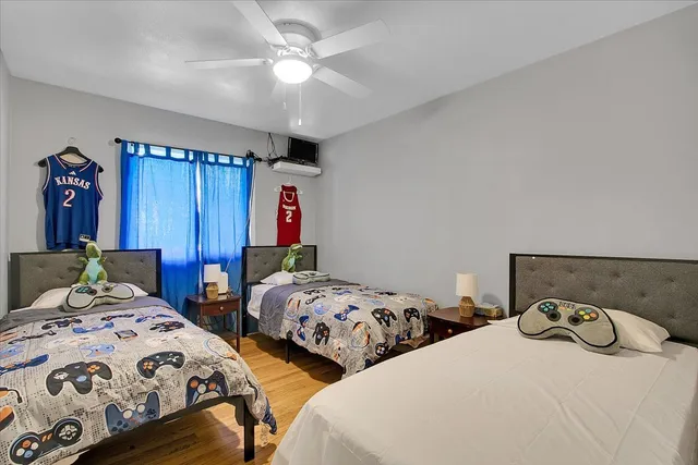 a bedroom with two beds and a chandelier