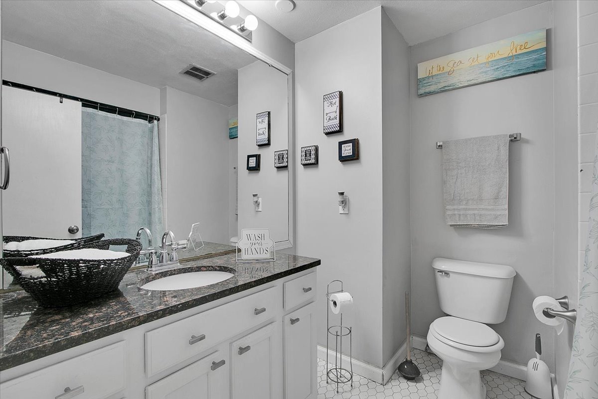 1708 Montague Road Rockford, IL 61102 - Photo 25 of 39 a bathroom with a granite countertop sink mirror and toilet